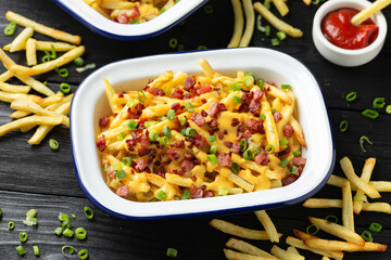 Crispy French fries loaded with bacon, cheese sauce and spring onion