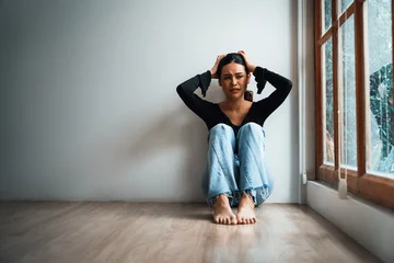 Fotobehang Depressed young Asian woman with mental health problem in mind need uttermost treatment from overthinking fatigue, disruptive thought, dissocial, anxiety and other mental health disorders . © Summit Art Creations