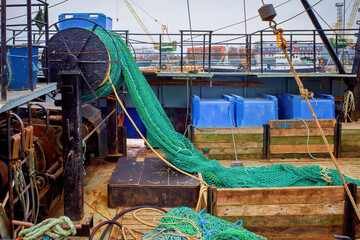 Fishing gear on a trawler. Roller with a net of a green fishing trawler. Selective focus.