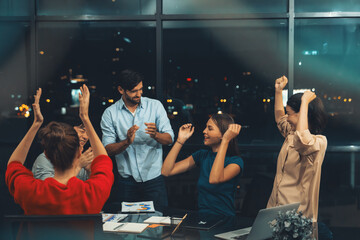 Successful businesspeople giving high five together while coworker clapping hands to celebrate successful project. Group of happy business people applause for getting promotion, bonus. Tracery.
