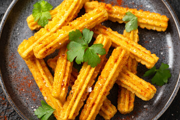 Crisp and golden Potato churros served with paprika and fresh parsley