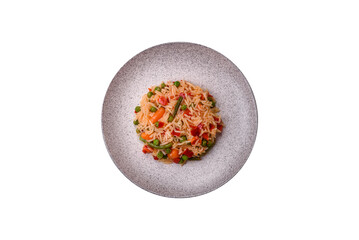Delicious boiled rice with vegetables peppers, green peas, salt, spices and herbs