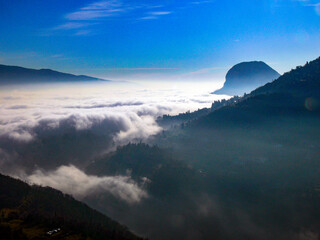 View from Tremosine on Lake Garda in southern direction. Lake Garda and Pieve are covered in fog.