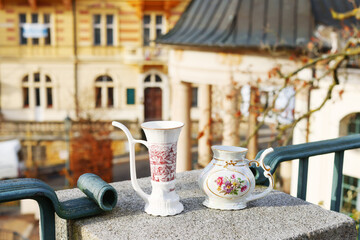 White cup for drinking therapeutic mineral water from natural hot springs.