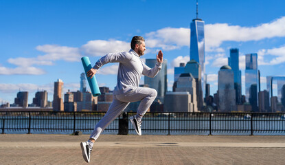 Sportsman jogger running or jogging. Man in sports suit training jogging. Running man in Manhattan....