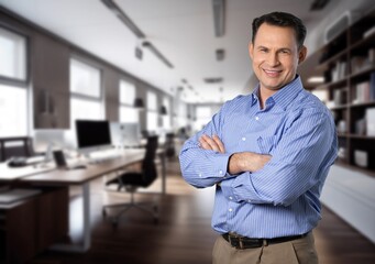 Happy business man standing in office.