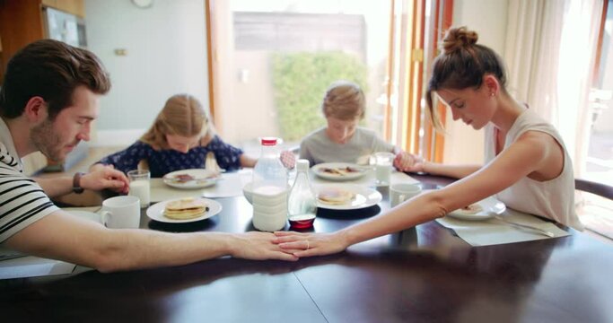 Breakfast, religious and family praying for food with gratitude for a meal in the morning in a home table. Children, parents and kids with spiritual mother and father pray to give thanks God