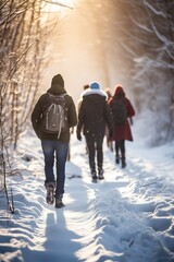 group of people walking well covered and with backpacks through the snow