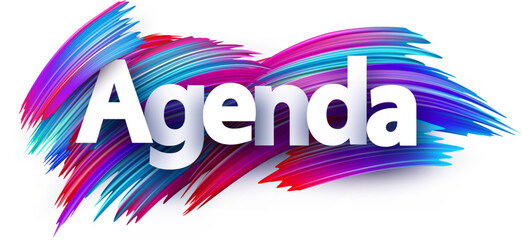 Agenda paper word sign with colorful spectrum paint brush strokes over white.