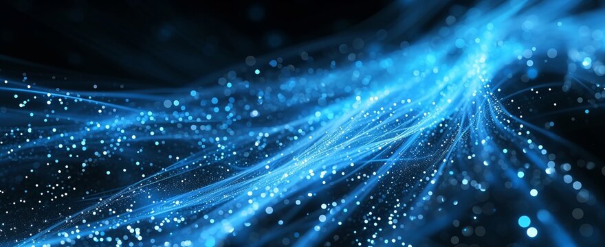 The image shows a swirl of blue lights on a black background. great image for a website or blog background
