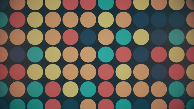 Trendy retro 1970s geometric background with colorful blinking circles in vintage colors - blue, orange, red and teal. This stylish  motion background animation is 4K and a seamless loop.