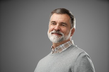 Portrait of happy casual mature man smiling, senior age man with gray hair, Isolated on gray background