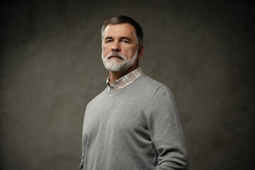 Portrait of happy casual mature man smiling, senior age man with gray hair, Isolated on dark gray background