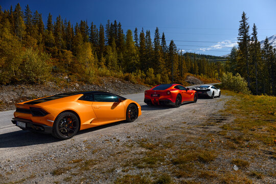Three super cars: yellow Lamborghini Huracan, red Ferrari F12 and white Mclaren 650s. Miland, Norway. 04.06.2016