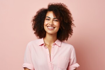 Obraz na płótnie Canvas Portrait of a smiling african american woman on pink background