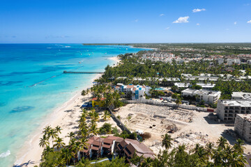 Fototapeta premium Tropical coastline with resorts, palm trees and caribbean sea. Dominican Republic. Aerial view