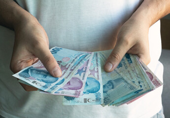 Man counting cash money. Business crisis finance concept. Close up a hand counting paper Turkish Liras. 