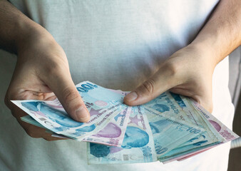 Man counting cash money. Business crisis finance concept. Close up a hand counting paper Turkish Liras. 