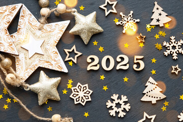Happy New Year-wooden letters and the numbers 2025 on festive black background with sequins, stars, snow. Greetings, postcard. Calendar, cover