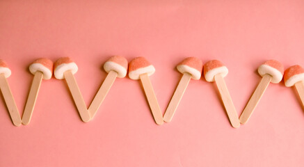 Four candy heart shape on peach fuzz background.