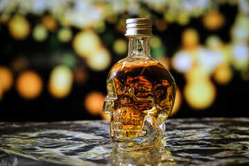 A bottle of drink, in the shape of a human skull