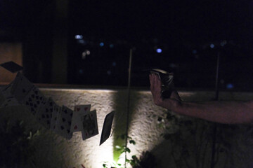 Playing cards fall on a gray backgraund.