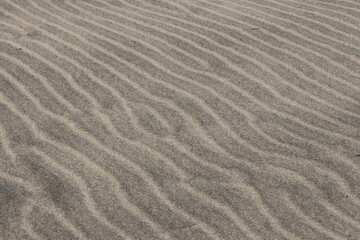 Fototapeta na wymiar Natural pattern on the beach sand, black and white.