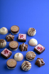 photography an assortment of chocolates, snack that tempts the taste buds. Against a rich background, the image captures the allure embodying the sweet pleasures of a treat 