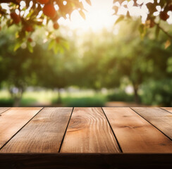 Naklejka na ściany i meble Empty wooden table, texture board, on a blurred background of an fruits garden in blurred bokeh