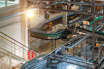 Modern automated beer bottling production line. Beer bottles moving on conveyor