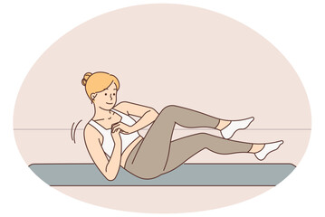 Sporty woman training on mat