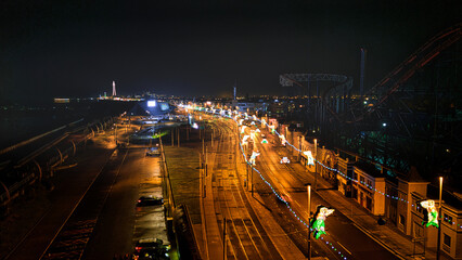 Fototapeta na wymiar Night cityscape with illuminated streets and traffic lights, showcasing urban life and transportation.