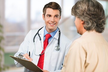 Smile doctor consulting patient in hospital for support.