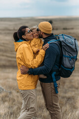 A traveling family. Traveling with a child. A traveling couple in hiking gear. Hiking with a...