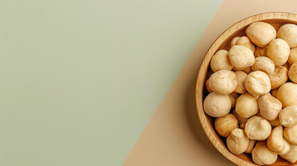 Shelled macadamia nuts on a green and beige background