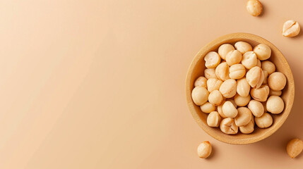 Shelled macadamia nuts in a bowl - obrazy, fototapety, plakaty