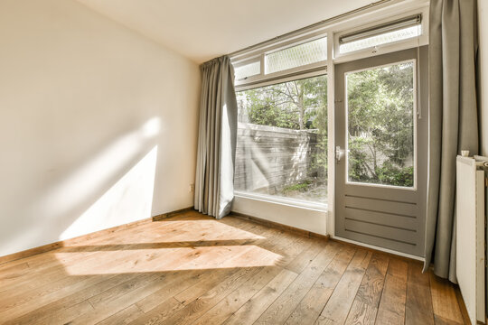 Living room with door and hardwood floor