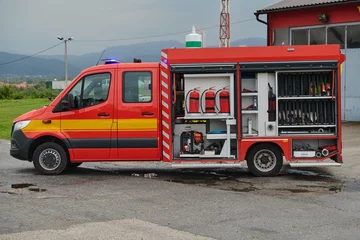 Foto op Canvas A state-of-the-art firetruck, equipped with advanced rescue technology, stands ready with its skilled firefighting team, prepared to intervene and respond rapidly to emergencies, ensuring the safety © .shock