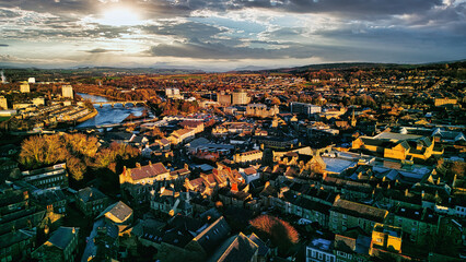 Aerial view of a city Lancaster at sunset with warm lighting, highlighting the urban landscape and...