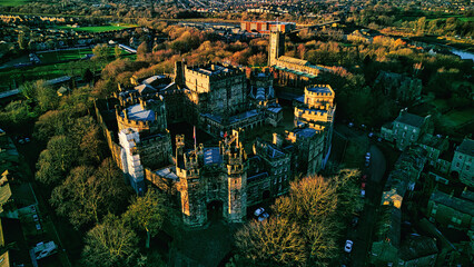 Aerial view of the Lancaster castle surrounded by greenery at sunset, showcasing the architecture...