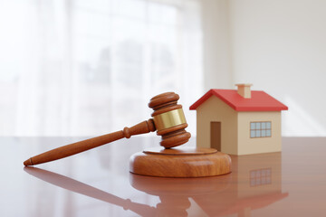 Wooden gavel and and house toy on wooden desk. Concept of real estate law. 3d illustration.