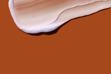 White cream smudge swatch textured brown orange colored background