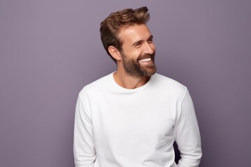 Handsome young man in white t-shirt on violet background