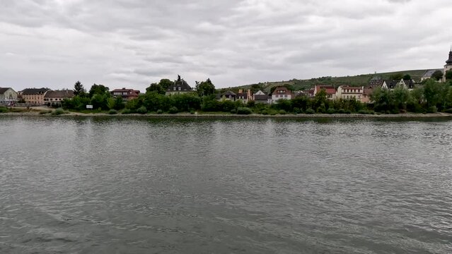 Traveling along the Rhine River with scenic views of the medieval town of Trebur, Germany. Views of colorful European style architecture and vineyards on the sloping land