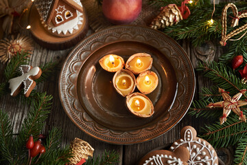 Candles made of bees wax and nut shells floating in a bowl of water - Christmas custom