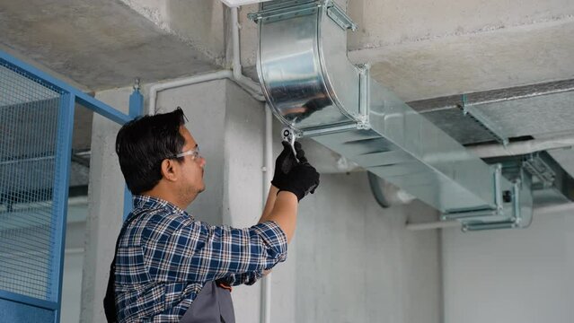 Professional Indian Heating and Cooling Technician Worker Finishing Newly Assembled Air Vent Shaft