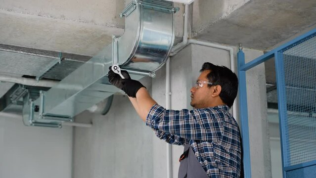 Indian hvac worker install ducted pipe system for ventilation and air conditioning