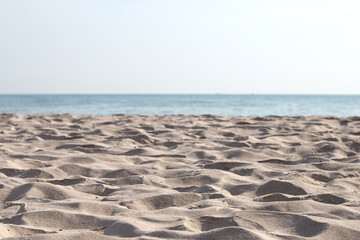 Fototapeta na wymiar Beach sand texture with sea and sky for background.