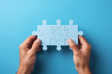 hands holding three blue puzzle pieces