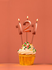 Birthday cupcake with candle number 121 - Coral fusion background